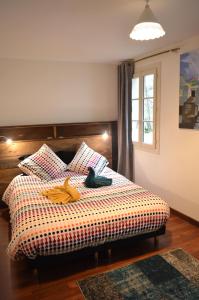 a bedroom with a bed with a colorful blanket at Matin d'été in Chartres