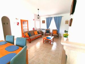a living room with a couch and a table at Azimute Guest House in Aljezur