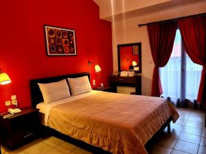 Ένα ή περισσότερα κρεβάτια σε δωμάτιο στο Ξενοδοχείο Οδυσσέας