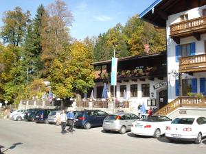 a group of cars parked in front of a building at Pension Oberwirt in Fischbachau
