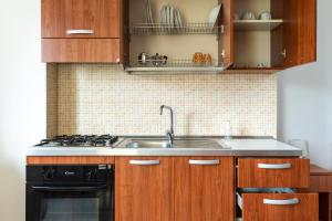 a kitchen with a sink and a stove at Residence Catona in Otranto