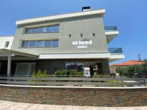 a building with the on hotel services sign on it at On Board Luxury Studios in Sarti