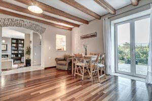 a kitchen and dining room with a table and chairs at Ktima Loumoumba, Private Villa in Gouvia
