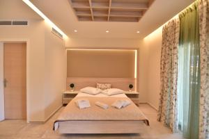 a bedroom with a bed with two pillows at On Board Luxury Studios in Sarti