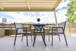 a table and two chairs on a patio at On Board Luxury Studios in Sarti