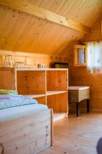 a room with two beds in a wooden cabin at Radlerstation-Sandhof in Berg im Drautal