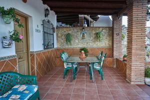 a table and chairs on an outdoor patio at Casa Rural Mi Cortijo in Nerja