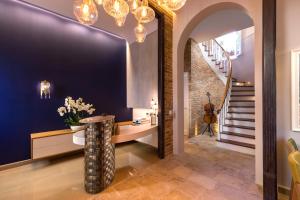 a hallway with a staircase and a table with flowers at Acanthus blue in Corfu Town