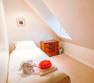 a bedroom with a bed and a dresser and a window at Harbour View in Portree