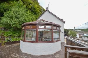 a house with a large window on the side of it at Fairhaven, Oban Town Centre in Oban