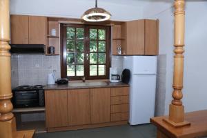 a kitchen with a white refrigerator and a sink at Casa Lanardi, Stavros in Stavros