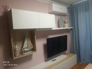 a living room with a tv and white cabinets at Marathon in Salou