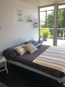 a bedroom with a large bed with pillows on it at Morat Gaste Zimmer in Murten