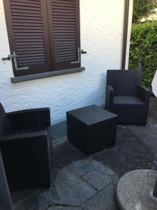 two chairs and a table on a patio at Appartamento Via Saleggi 10 in Ascona