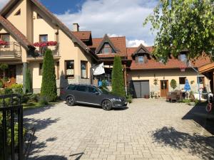 a car parked in a driveway in front of a house at Privát Migáč in Vrbov