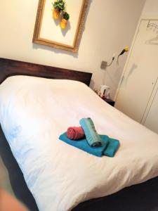 a bed with two towels sitting on top of it at H 58 in Amsterdam