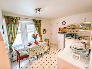 a kitchen with a small table and a kitchen with a window at Harbour View in Portree