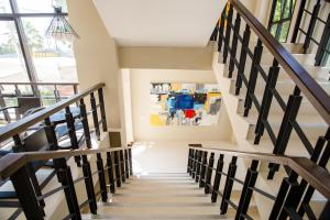a staircase in a house with a painting on the wall at Naka Residence in Phuket