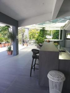 a lobby with a bar with chairs and plants at Dela in Hvar
