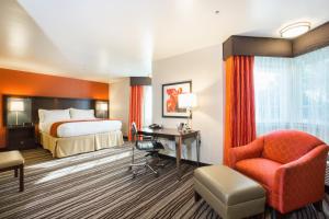 a hotel room with a bed and a desk and a chair at Holiday Inn Express Mountain View South Palo Alto by IHG in Mountain View