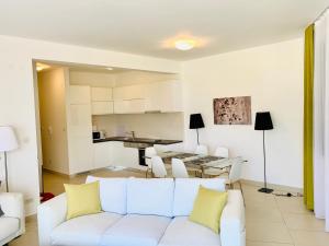 a living room with a white couch and a table at Lavender Bay Apartment B13 in Donji Morinj +18 photos