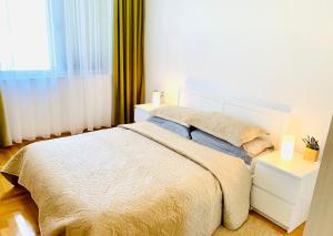 a bedroom with a white bed and a window at Lavender Bay Apartment B13 in Donji Morinj