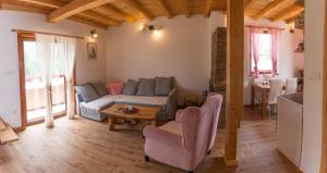 a living room with a couch and a table at Planinska kuca Popovic 3 in Ljuboš +47 photos