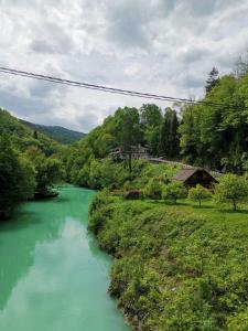 a river with turquoise green water in a valley at Penzion Šterk in Most na Soči