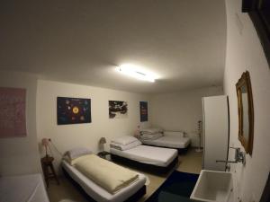 Zimmer mit 3 Betten und einem Waschbecken. in der Unterkunft Ferienwohnung Kaffeewerkstatt in St. Wolfgang