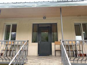 a front door of a house with a porch at Panorama Kazbegi in Stepantsminda