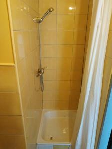 a bathroom with a shower with a tub at Kawalerki z Kuchnią - self check in - Studios with Kitchen in Poznań +14 photos