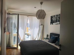 a bedroom with a bed and a large window at Messe-Congress Central with balcony in Vienna