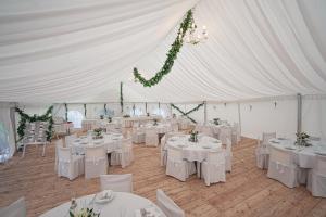 a white tent with tables and chairs in it at Hotel Racek in Úštěk