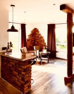 a living room with a brick fireplace and a table at Gästehaus Annel in Niederhorbach