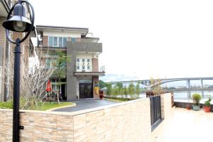 a house with a stone wall and a street light at Ashore 196 B&B in Dongshan