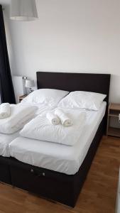 コウォブジェクにあるApartament Bałtyckaのベッド(白いシーツ、白いタオル付)