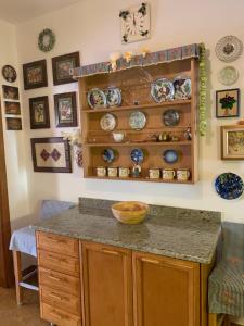 a kitchen with a counter with plates on the wall at Rozita Seaside Relax Apartments in Podgora