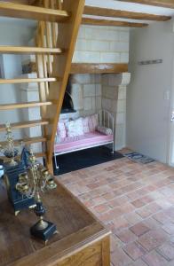 een kamer met een bed in een kamer met een trap bij Pergoloire in La Bohalle