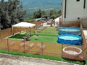 two swimming pools in a fenced in area with two at Villa Santa Maria in Santa Maria del Molise