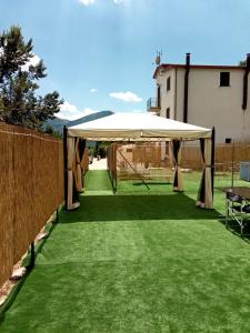 a large white tent on a lawn with a fence at Villa Santa Maria in Santa Maria del Molise