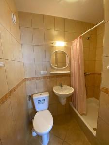 a small bathroom with a toilet and a sink at Pokoje Gościnne SŁONECZKO Władysławowo in Władysławowo