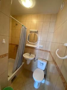 a small bathroom with a toilet and a sink at Pokoje Gościnne SŁONECZKO Władysławowo in Władysławowo