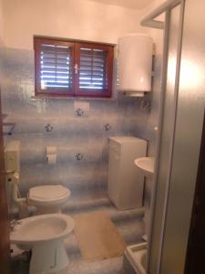 a bathroom with two toilets and a sink at Apartment Marija in Krk +17 photos