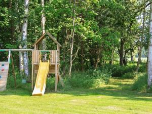 a playground with a slide in a park at 14 person holiday home in Str by in Strøby