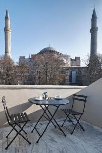 a table and chairs on a balcony with a view of a city at Boutique Saint Sophia in Istanbul
