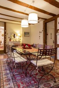 a dining room with a table and chairs at La Maison des Tanneurs in Ribeauvillé