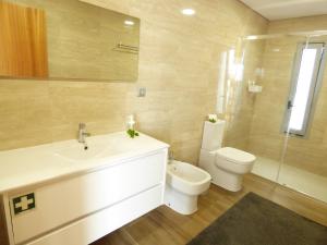 a bathroom with a sink and a toilet at Moradia Faria in Fataca