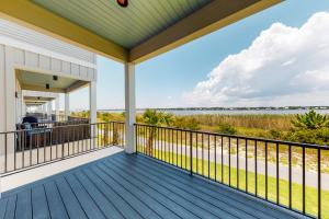 a large deck with a view of the water at West Side Cottage #OO in Gulf Shores