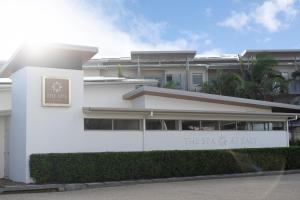 a large white building with a large window at Peppers Salt Resort & Spa in Kingscliff