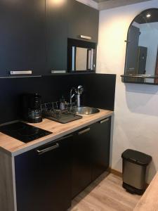 a kitchen with a sink and a counter top at Studio rénové - Val Claret centre - Exposition sud in Tignes